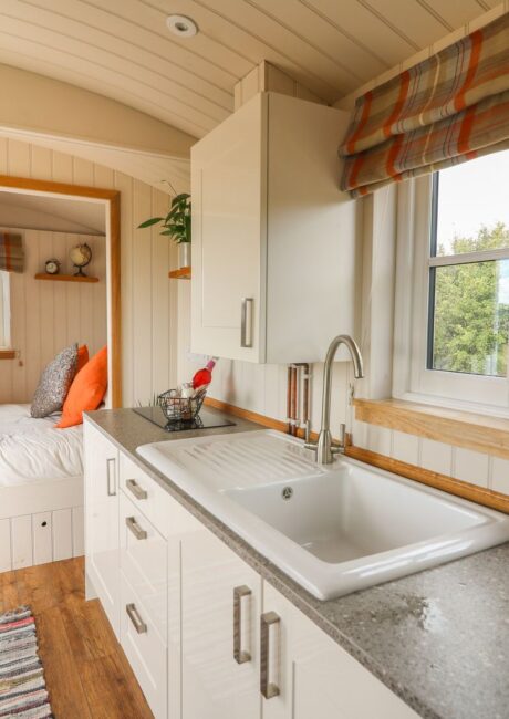 A kitchen with a bed and a window.